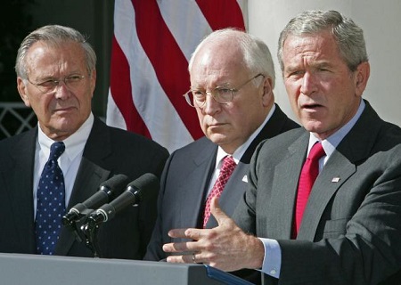 Then-President George W. Bush (r.) speaks on the war on terrorism as former Secretary of Defense Donald Rumsfeld (l.) and former Vice President Dick Cheney (c.) look on in September 2005. The elder Bush criticized his son's “hot rhetoric.